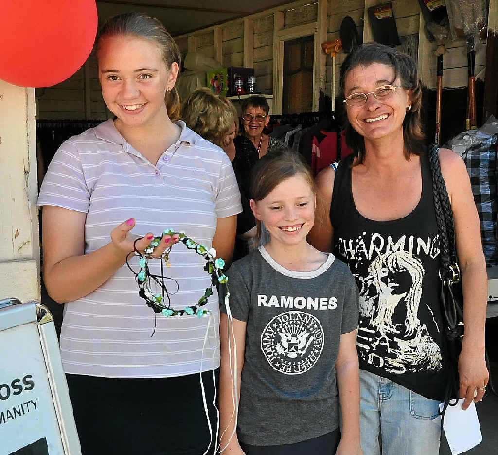 Genevieve, 12, Tiffany, 10, and Vickie Walker find a bargain.